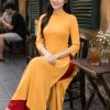Áo dài biểu diễn tà rộng vàng cam tại Trang Phục Bông Sen